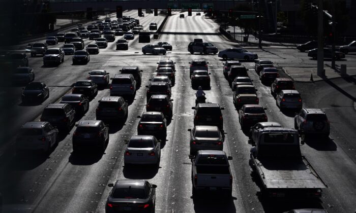 Cars wait at a red light during rush hour at the Las Vegas Strip in Las Vegas on April 22, 2021. (John Locher/AP Photo)