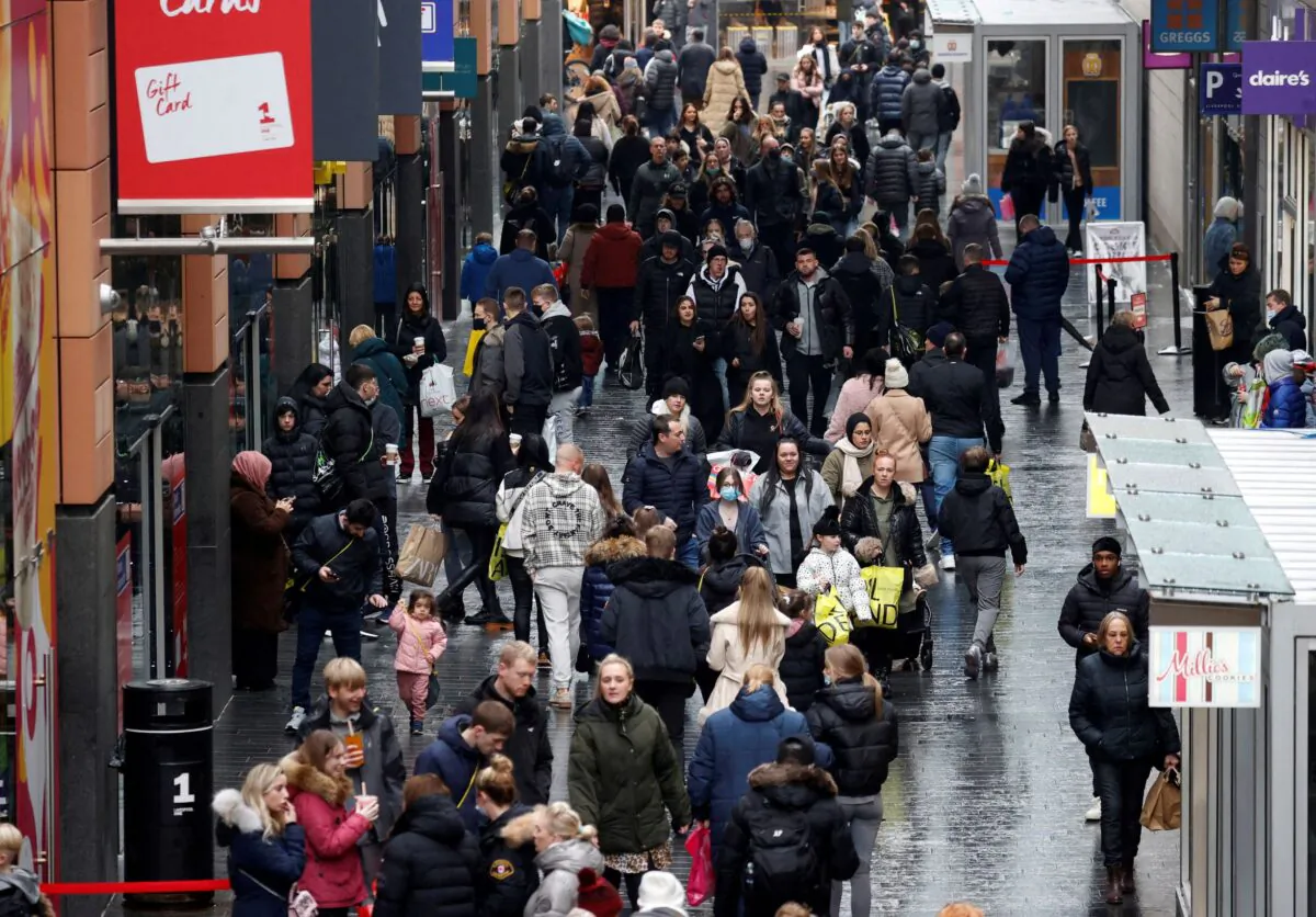 People walk along a busy shopping street as people look for bargains in the traditional Boxing Day sales in Liverpool, Britain, on Dec. 26 , 2021. (Phil Noble/Reuters)