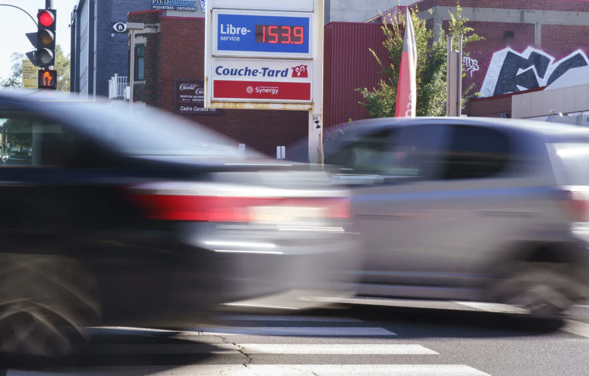 Cars drive by a gas station in Montreal on Oct. 20, 2021. (The Canadian Press/Paul Chiasson)