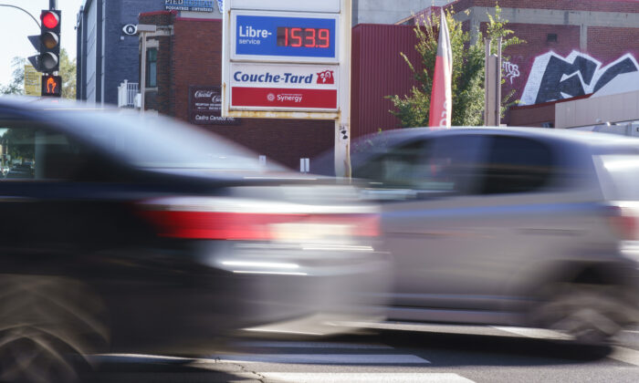 Cars drive by a gas station in Montreal on Oct. 20, 2021. (The Canadian Press/Paul Chiasson)