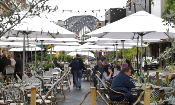 People enjoy their drinks in Sydney on October 11, 2021, as the city ended their lockdown against the Covid-19 coronavirus after 106 days and restaurants began throwing open their doors to anyone who could prove they were vaccinated. (Photo by Saeed Khan/AFP via Getty Images)