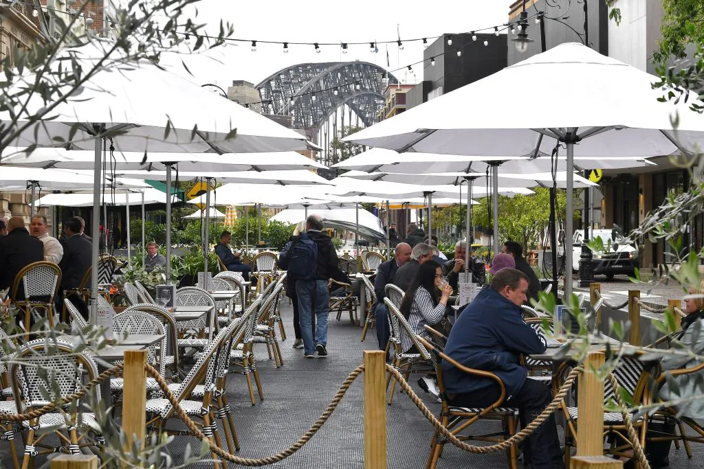 People enjoy their drinks in Sydney on October 11, 2021, as the city ended their lockdown against the Covid-19 coronavirus after 106 days and restaurants began throwing open their doors to anyone who could prove they were vaccinated. (Photo by Saeed Khan/AFP via Getty Images)