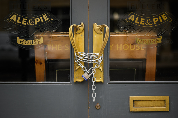 A padlock and chain secures the door of a temporarily-closed pub on February 10, 2021 in London, England. (Photo by Leon Neal/Getty Images)