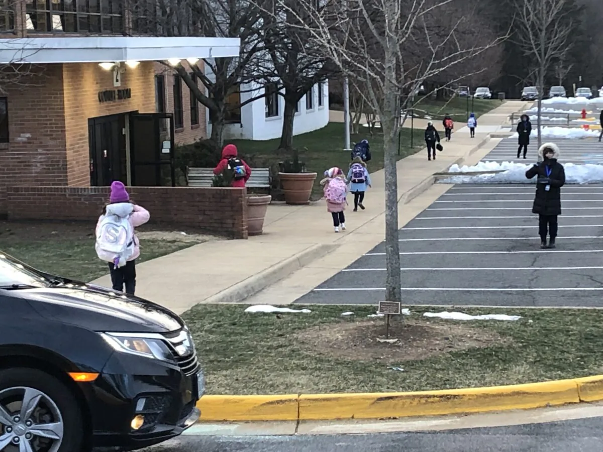 Students arrive at Our Lady of Good Counsel, a school in the Catholic Diocese of Arlington, in Vienna, Va., on Jan. 21, 2022, the last school day that masks are mandated for students. (Terri Wu/The Epoch Times)