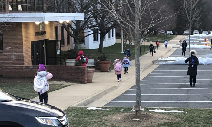 Students arrive at Our Lady of Good Counsel, a school in the Catholic Diocese of Arlington, in Vienna, Va., on Jan. 21, 2022, the last school day that masks are mandated for students. (Terri Wu/The Epoch Times)