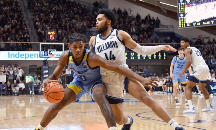 Marquette Golden Eagles forward Justin Lewis (10) is defended by Villanova Wildcats guard Caleb Daniels (14), during the second half at William B. Finneran Pavilion in Villanova, Pa., on Jan. 19, 2022. (Eric Hartline/USA TODAY Sports via Field Level Media)
