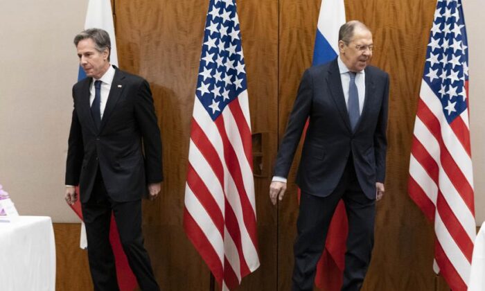 U.S. Secretary of State Antony Blinken, left, and Russian Foreign Minister Sergey Lavrov move to their seats before their meeting in Geneva, Switzerland, on Jan. 21, 2022. (Alex Brandon/AP Photo)