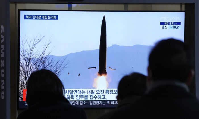 People watch a TV showing a file image of North Korea's missile launch shown during a news program at the Seoul Railway Station in Seoul, South Korea, on Jan. 20, 2022. (Ahn Young-joon/AP Photo)