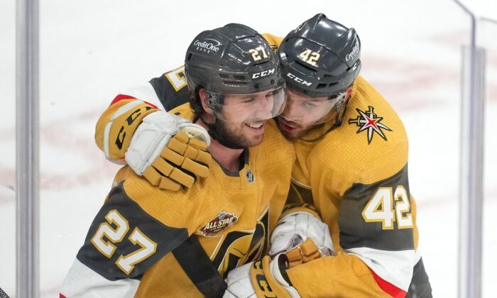 Vegas Golden Knights defenseman Shea Theodore (27) is embraced by forward Daniil Miromanov (42) after scoring the game winning goal against the Montreal Canadiens at T-Mobile Arena, in Las Vegas, on Jan. 20, 2022. (Stephen R. Sylvanie/USA TODAY Sports via Field Level Media)