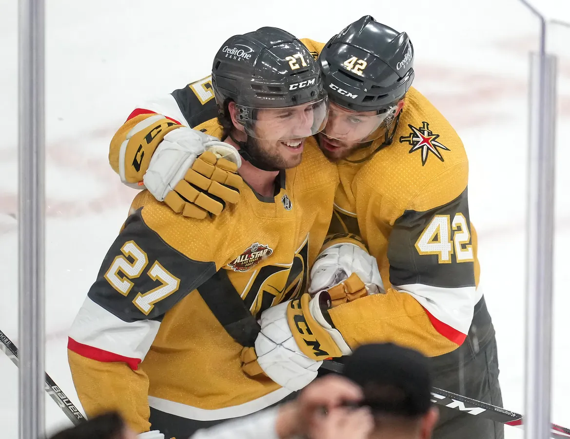 Vegas Golden Knights defenseman Shea Theodore (27) is embraced by forward Daniil Miromanov (42) after scoring the game winning goal against the Montreal Canadiens at T-Mobile Arena, in Las Vegas, on Jan. 20, 2022. (Stephen R. Sylvanie/USA TODAY Sports via Field Level Media)