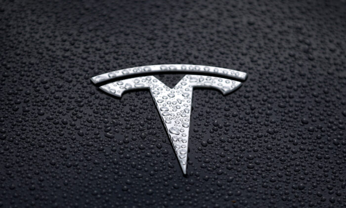 The Tesla logo is displayed on the hood of a Tesla car in Corte Madera, Calif., on May 20, 2019. (Justin Sullivan/Getty Images)