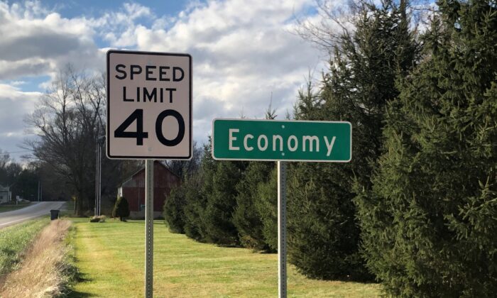 A speed limit sign is seen beside a city sign for Economy, Ind., on Nov. 10, 2020. (Timothy Aeppel/Reuters)