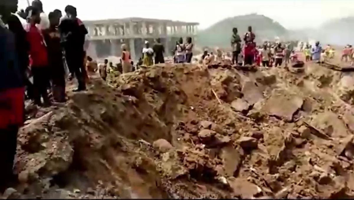 This screenshot taken from a video posted on social media shows a massive crater in the ground following an explosion in Ghana's rural Western Region, Ghana, on Jan. 20, 2022. (Joseph Kabenlah Amihere via Reuters)