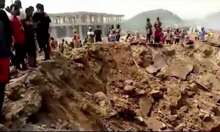 This screenshot taken from a video posted on social media shows a massive crater in the ground following an explosion in Ghana's rural Western Region, Ghana, on Jan. 20, 2022. (Joseph Kabenlah Amihere via Reuters) 