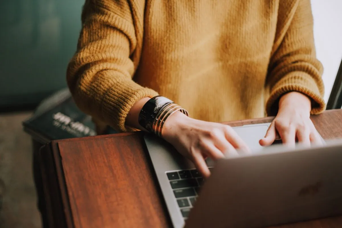A person typing on a laptop. (Christine Hume/Unsplash)