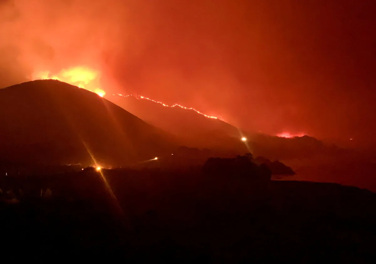Wildfire burns in Rocky Point of Monterey County, Calif., on the night of Jan. 21 or 22, 2022. (Debi Lorench/Handout via Reuters)