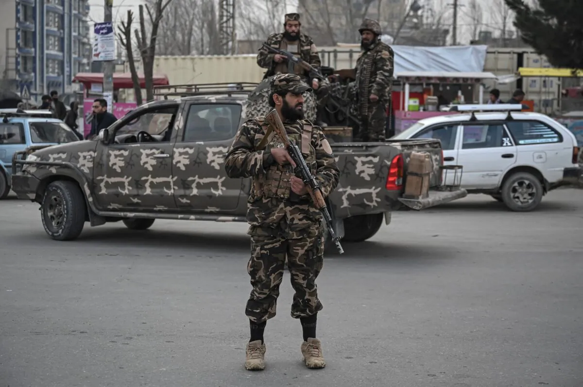 Taliban extremists stand guard along a street during a demonstration by people to condemn the recent protest by the Afghan women's rights activists, in Kabul, on Jan. 21, 2022. (Mohd Rasfan/AFP via Getty Images)