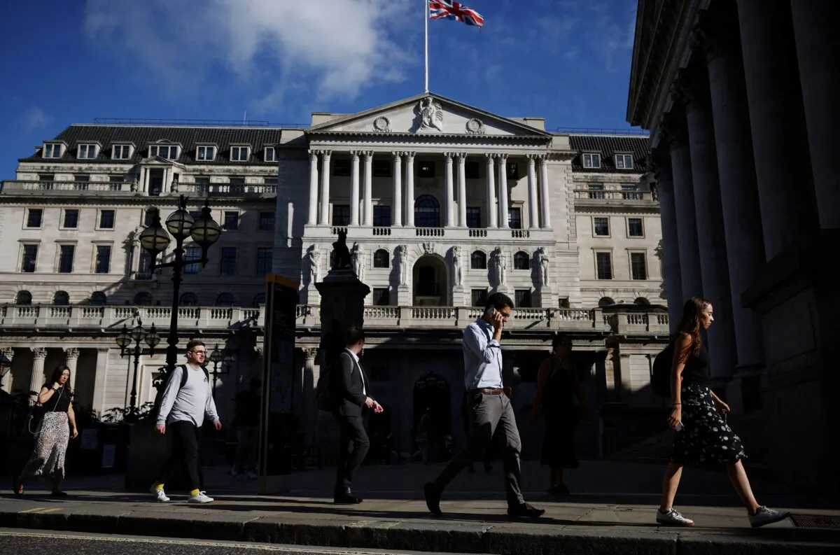 People walk past the Bank of England during morning rush hour, in London, on July 29, 2021. (Henry Nicholls/Reuters)