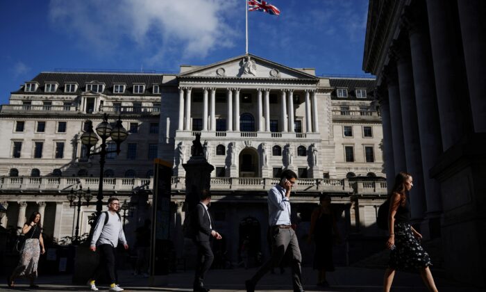 People walk past the Bank of England during morning rush hour, in London, on July 29, 2021. (Henry Nicholls/Reuters)