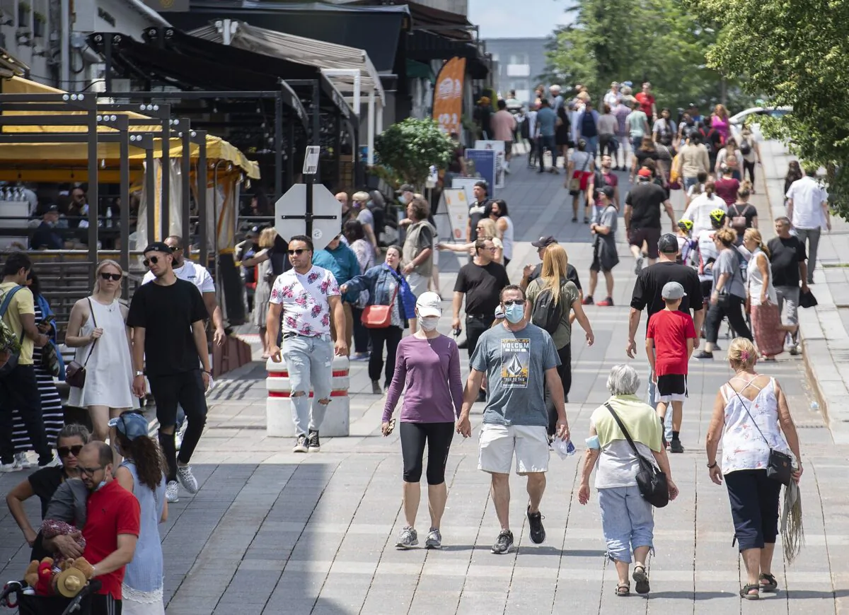 Pedestrians stroll through Place Jacques-Cartier in Old Montreal on July 4, 2021. (The Canadian Press/Graham Hugh)