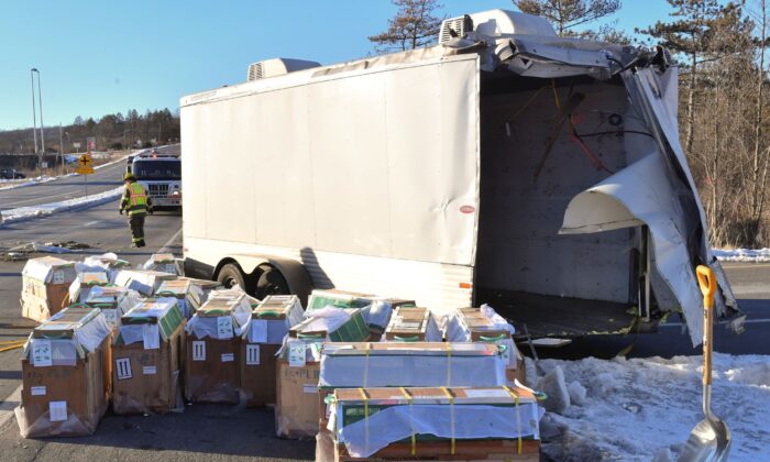 Crates holding live monkeys are collected next to the trailer they were being transported in along state Route 54 at the intersection with Interstate 80 near Danville, Pa., on Jan. 21, 2022. (Jimmy May/Bloomsburg Press Enterprise via AP)