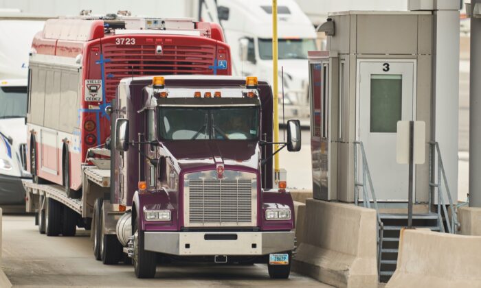 A trucker waits at the Canada Customs booth in Sarnia, Ont., on March 16, 2020. (Geoff Robins/AFP via Getty Images)