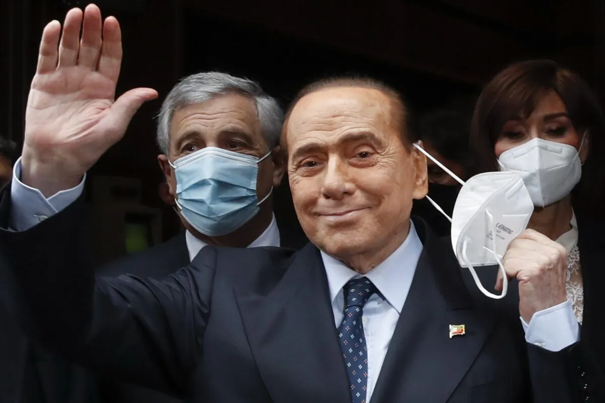 Former Italian Premier Silvio Berlusconi waves to reporters as he arrives at the Chamber of Deputies to meet Mario Draghi, in Rome, on Feb. 9, 2021. Alessandra Tarantino/AP Photo)
