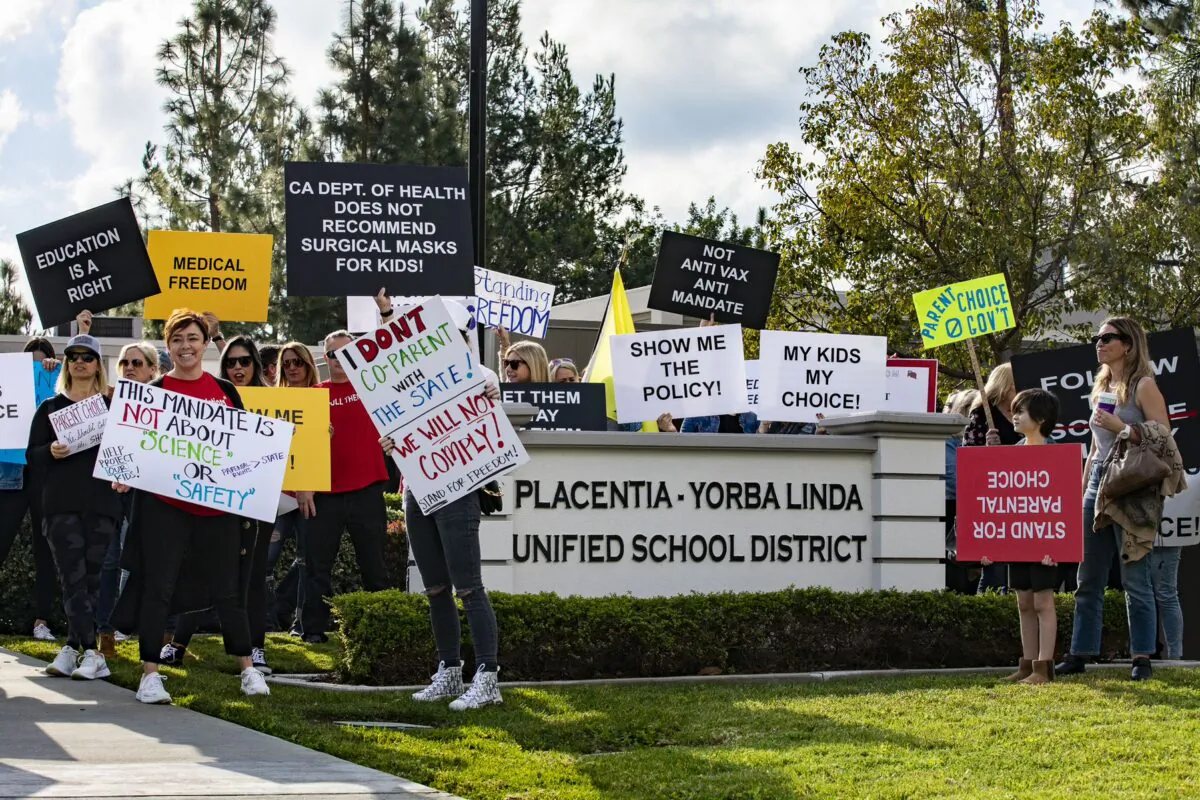 Parents and students gather in protest of the school district's policy at the Placentia Yorba Linda Unified School District offices in Placentia, Calif., on Jan. 18, 2022. (John Fredricks/The Epoch Times)