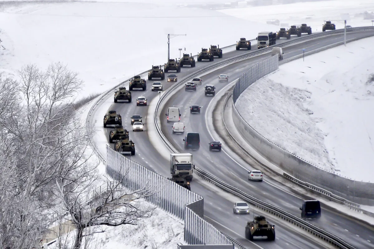 A convoy of Russian armored vehicles moves along a highway in Crimea, on Jan. 18, 2022.  (AP Photo)