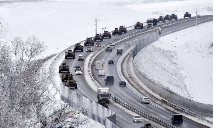 A convoy of Russian armored vehicles moves along a highway in Crimea, on Jan. 18, 2022.  (AP Photo)