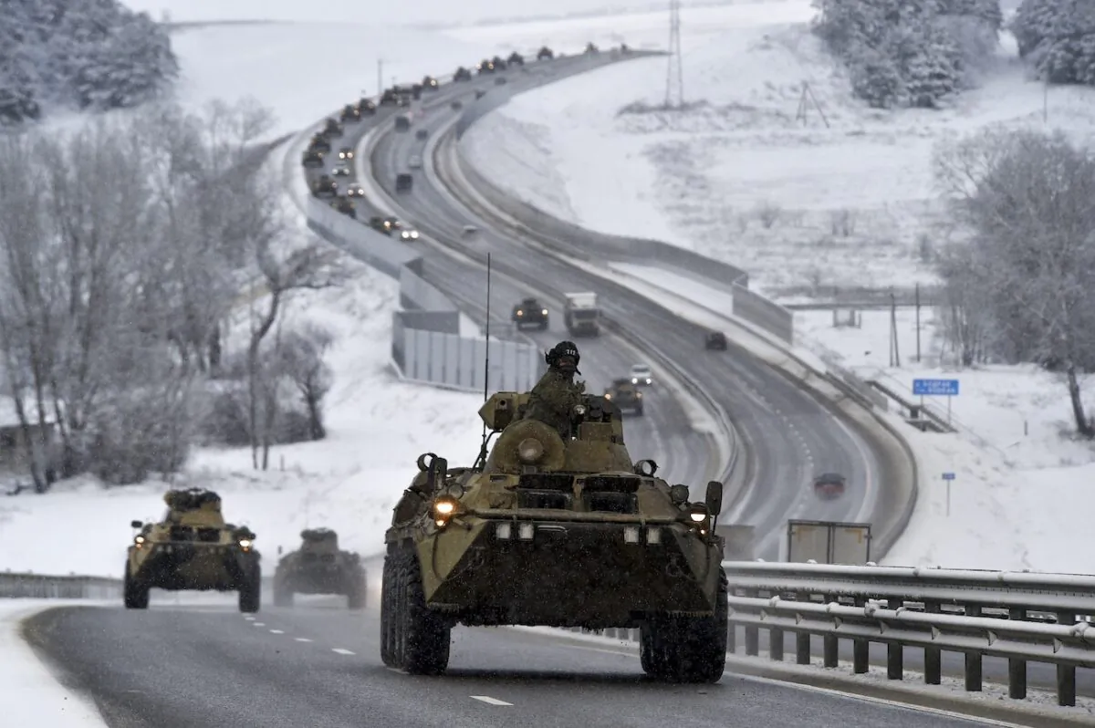 A convoy of Russian armored vehicles moves along a highway in Crimea on Jan. 18, 2022. (AP Photo)