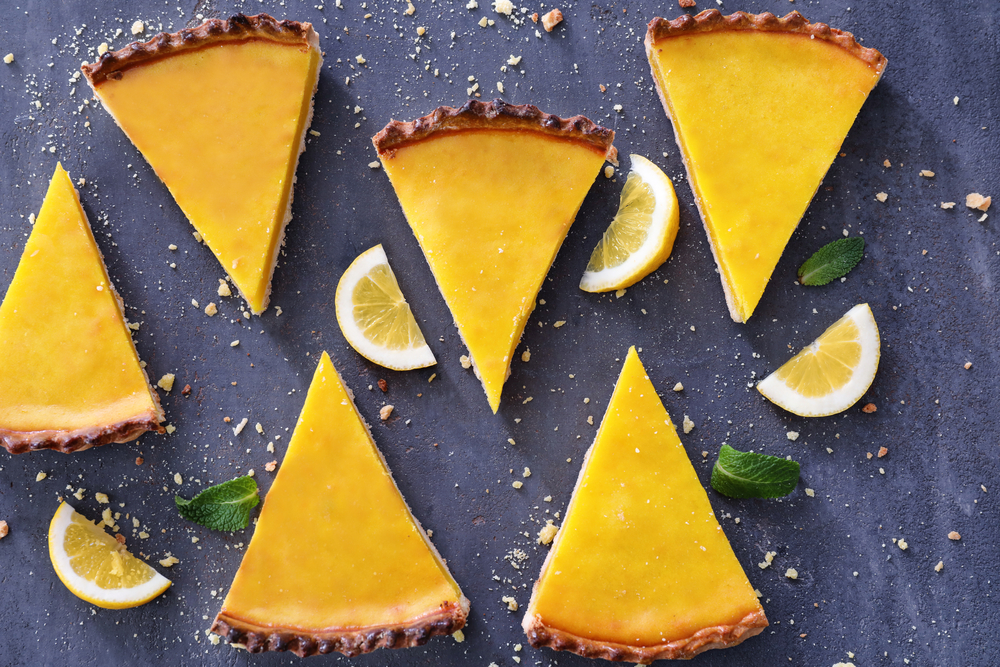 Composition,With,Pieces,Of,Delicious,Lemon,Pie,On,Textured,Background