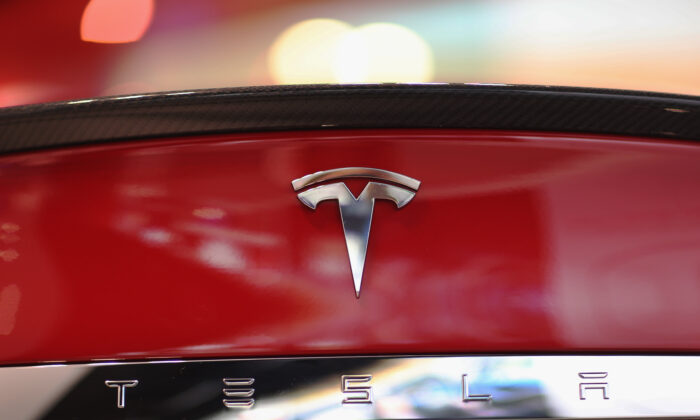 A Tesla motor company car logo sits on a car in a dealership at the Dadeland Mall in Miami, on June 6, 2013. (Joe Raedle/Getty Images)