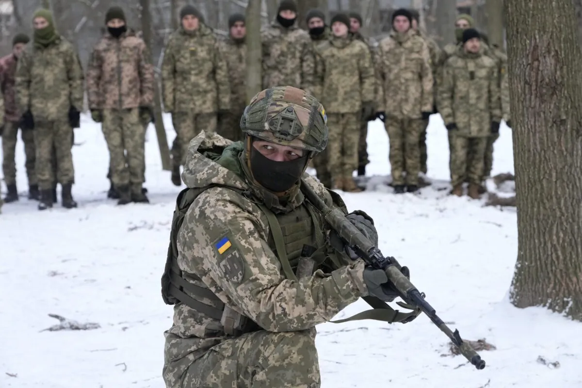 An instructor trains members of Ukraine's Territorial Defense Forces, volunteer military units of the Armed Forces, in a city park in Kyiv, Ukraine, on Jan. 22, 2022. (Efrem Lukatsky/AP Photo)