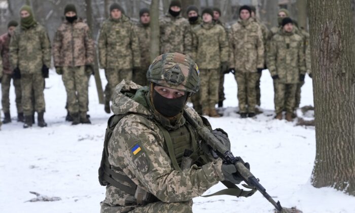 An instructor trains members of Ukraine's Territorial Defense Forces, volunteer military units of the Armed Forces, in a city park in Kyiv, Ukraine, on Jan. 22, 2022. (Efrem Lukatsky/AP Photo)