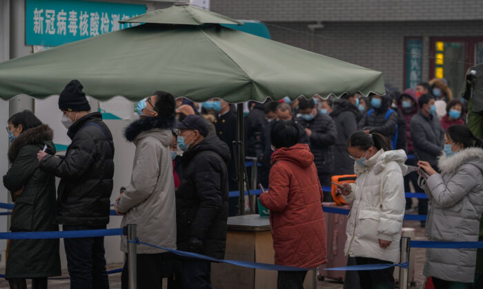 People line up to get a swab for the COVID-19 test at a hospital in Beijing, on Jan. 23, 2022. (Andy Wong/AP Photo)