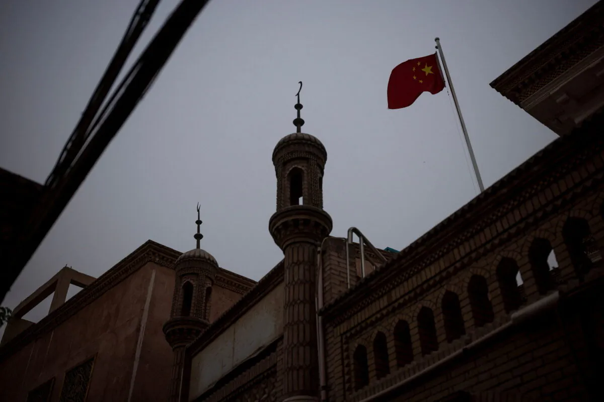 The Chinese national flag flies over a mosque in the old city in Kashgar, Xinjiang Uyghur Autonomous Region, China, May 4, 2021. (Thomas Peter/Reuters)