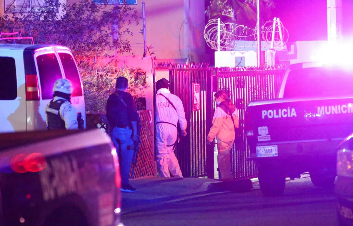 Members of a forensic team walk near at the crime scene where a Mexican journalist Lourdes Maldonado was shot dead outside her home in the northern border city of Tijuana, Mexico, ON Jan. 23, 2022. (Jorge Duenes/Reuters)