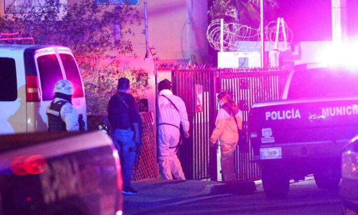 Members of a forensic team walk near at the crime scene where a Mexican journalist Lourdes Maldonado was shot dead outside her home in the northern border city of Tijuana, Mexico, ON Jan. 23, 2022.  (Jorge Duenes/Reuters)