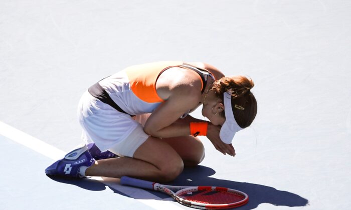 Alize Cornet of France reacts after defeating Simona Halep of Romania in their fourth round match at the Australian Open tennis championships in Melbourne, Australia, on Jan. 24, 2022. (Andy Brownbill/AP Photo)