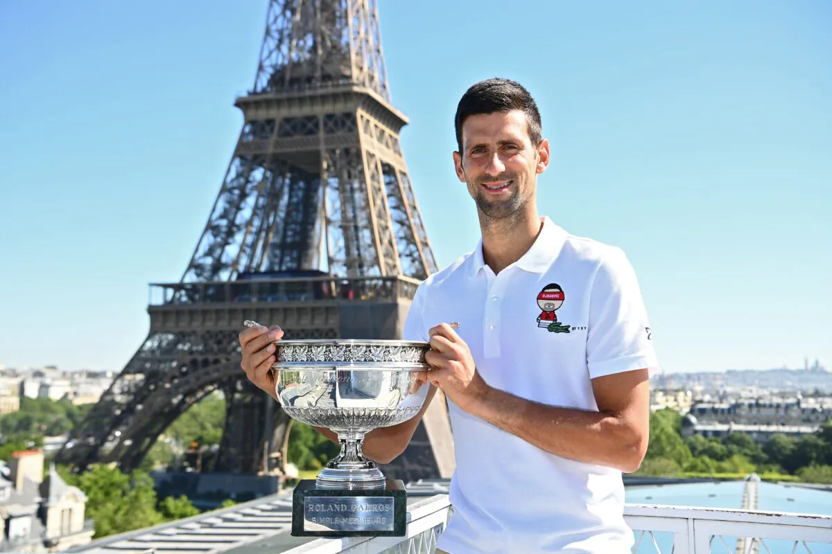 Serbia's Novak Djokovic poses with the trophy in front of the Eiffel tower, on June 14, 2021, in Paris, during a photocall one day after winning  the Roland Garros 2021 French Open tennis tournament. (Christophe Archambault/Pool/AFP via Getty Images)