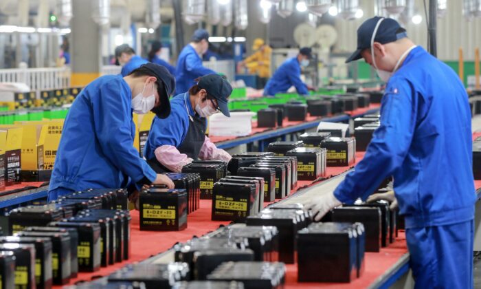 This photo taken on March 30, 2020 shows employees working on a battery production line at a factory in Huaibei in China's eastern Anhui province. (STR/AFP via Getty Images)