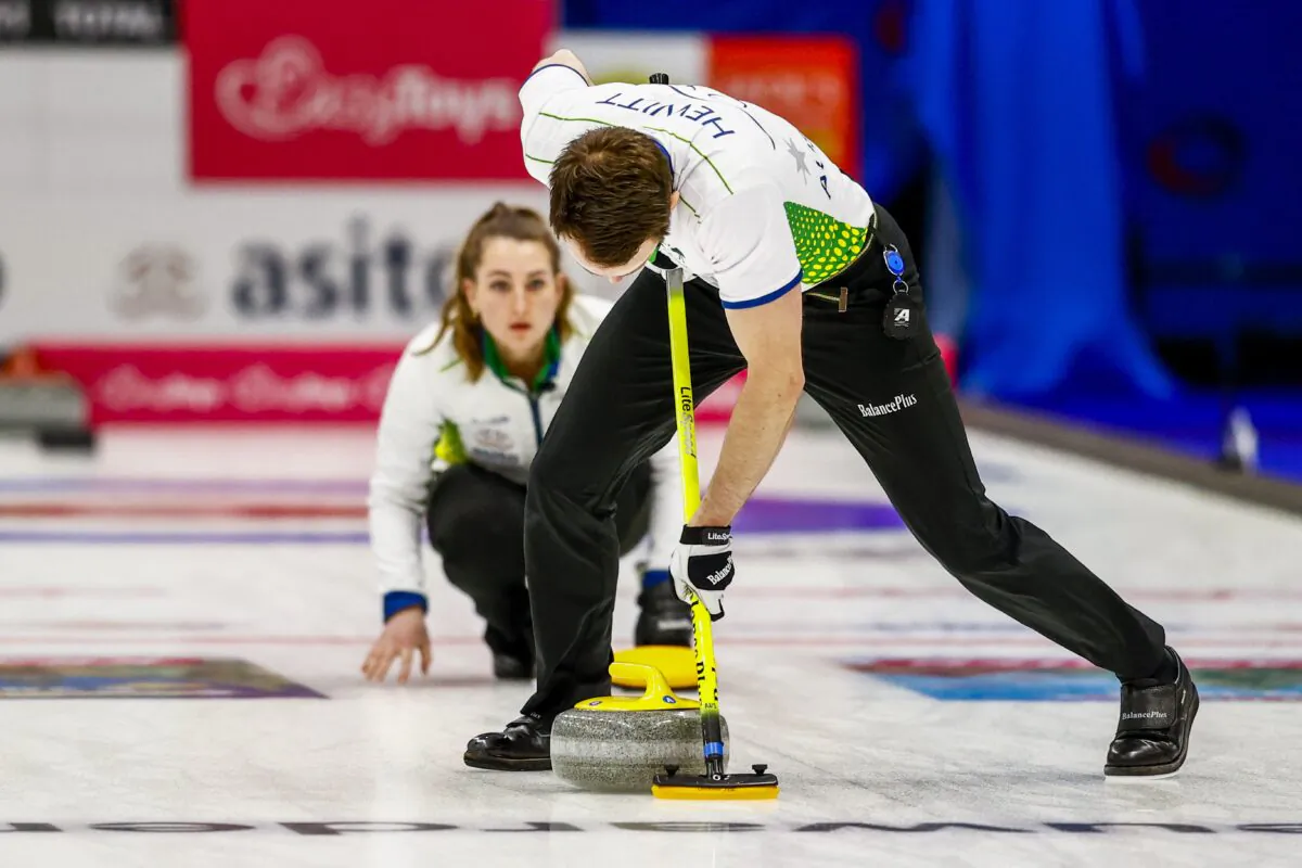Australia's Tahli Gill and Dean Hewitt compete in the mixed-team curling qualifying tournament for the Beijing 2022 Winter Olympics, at the Eleven Cities Hall, in Leeuwarden, the Netherlands, on Dec. 8, 2021. (Vincent Jannink/ANP/AFP via Getty Images)