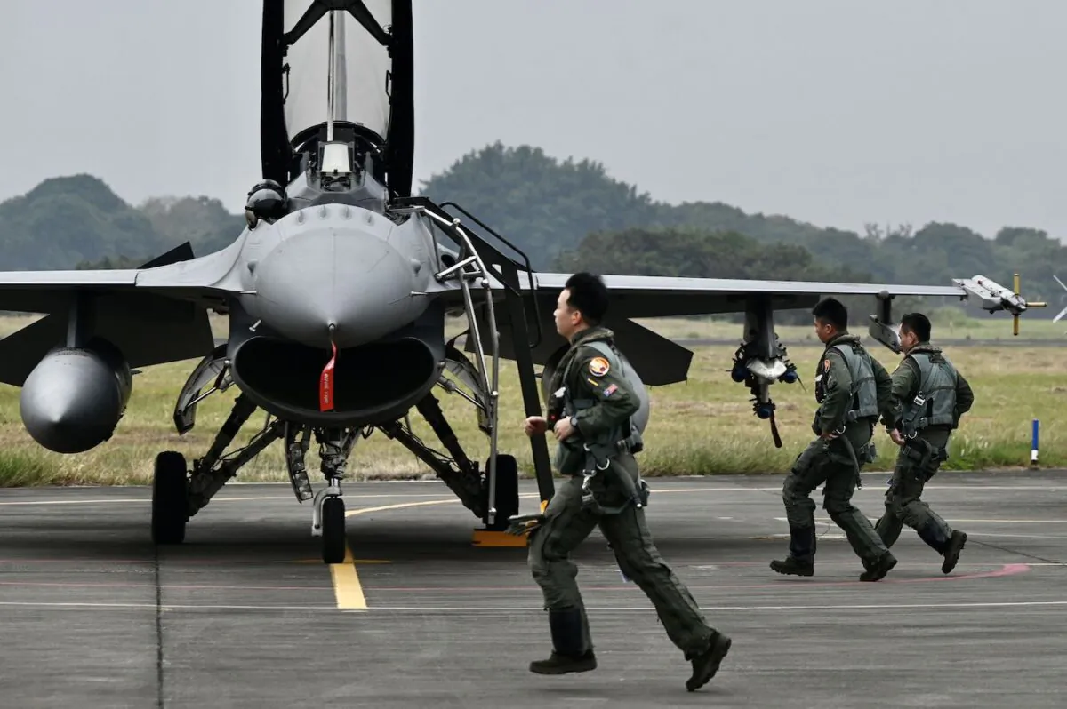 Taiwanese air force pilots run to their armed U.S.-made F-16V fighter at an air force base in Chiayi, Taiwan, on Jan. 5, 2022. (Sam Yeh/AFP via Getty Images)