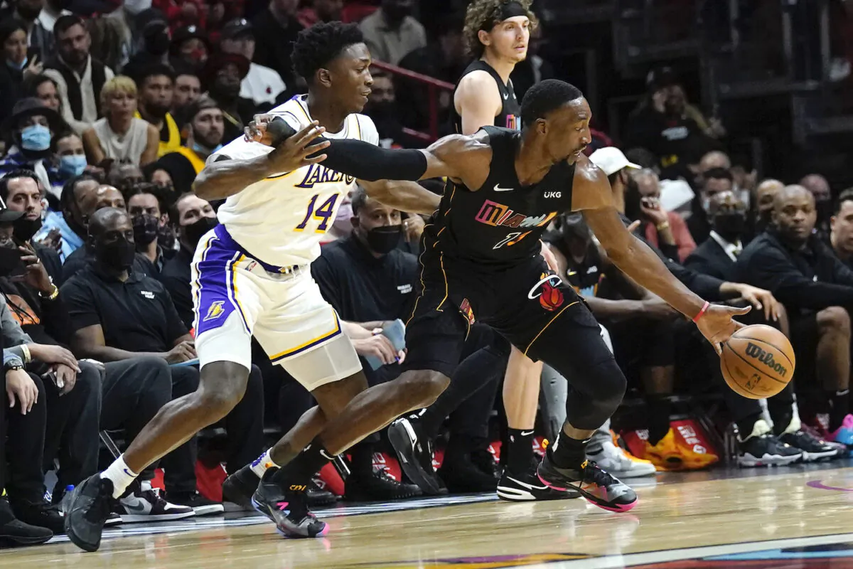 Miami Heat center Bam Adebayo (13) drives to the basket as Los Angeles Lakers forward Stanley Johnson (14) defends during the first half of an NBA basketball game in Miami on Jan. 23, 2022. (Lynne Sladky/AP Photo)