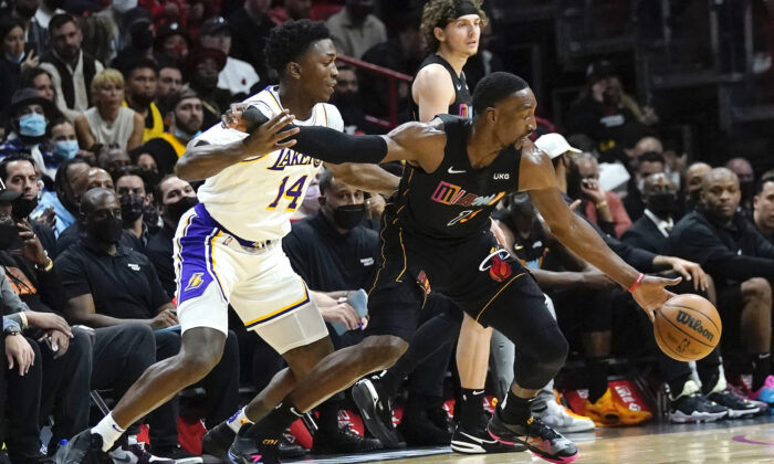 Miami Heat center Bam Adebayo (13) drives to the basket as Los Angeles Lakers forward Stanley Johnson (14) defends during the first half of an NBA basketball game in Miami on Jan. 23, 2022. (Lynne Sladky/AP Photo)