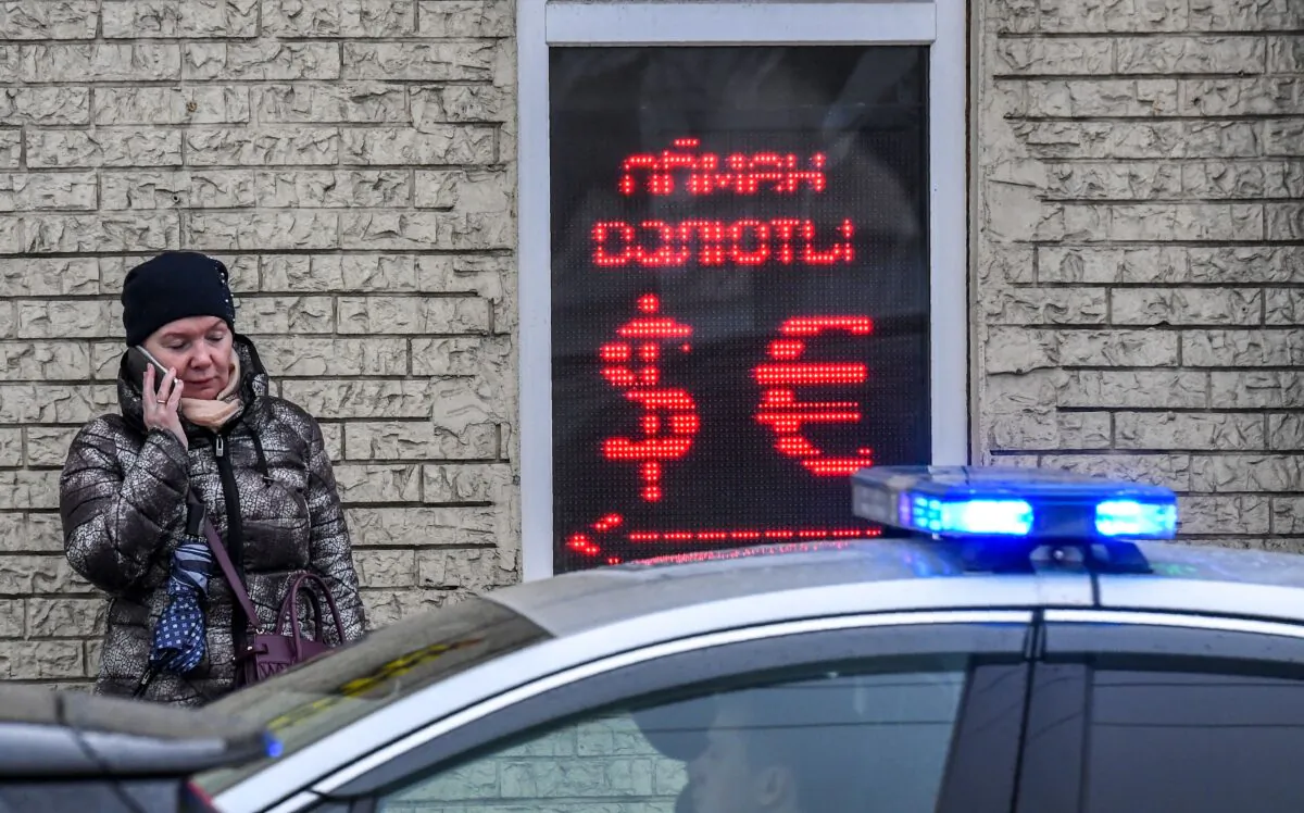 A woman speaks on a smartphone outside a currency exchange office in Moscow, Russia, on March 10, 2020. (Yuri Kadobnov/AFP/Getty Images)