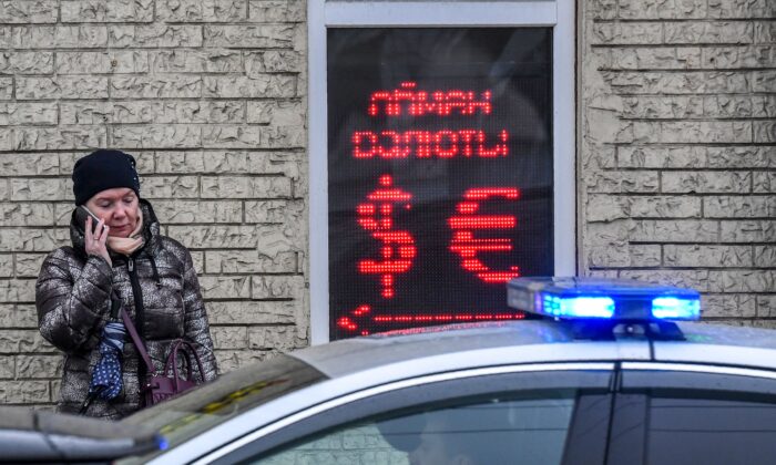 A woman speaks on a smartphone outside a currency exchange office in Moscow, Russia, on March 10, 2020. (Yuri Kadobnov/AFP/Getty Images)