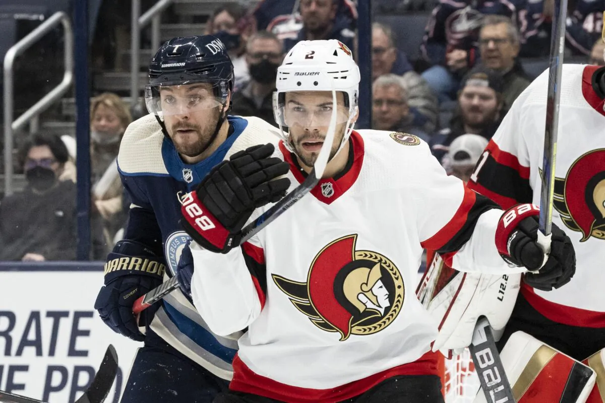 Columbus Blue Jackets center Sean Kuraly (7) and Ottawa Senators defenseman Artem Zub (2) battle in front of the Ottawa Senators goal in the third period at Nationwide Arena, in Columbus, Ohio, on Jan. 23, 2022. (Greg Bartram/USA TODAY Sports via Field Level Media)