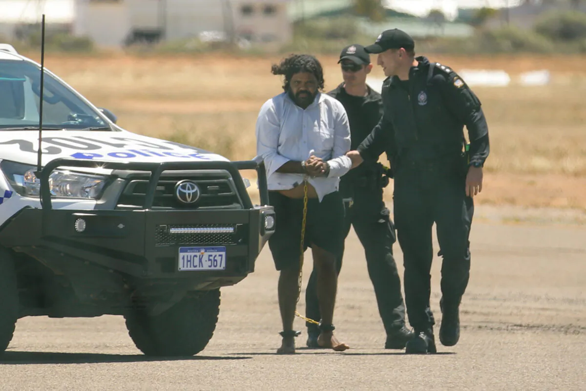 Terence Darrell Kelly boards a plane after being taken into custody by members of the Special Operations Group at Carnarvon airport in Carnarvon, Australia, on Nov. 5, 2021. (Tamati Smith/Getty Images)